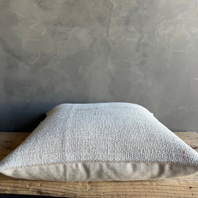Creamy white hemp rug pillow with original seams. Soft hand, linen blend backing with zipper closure. Spot cleaning is...