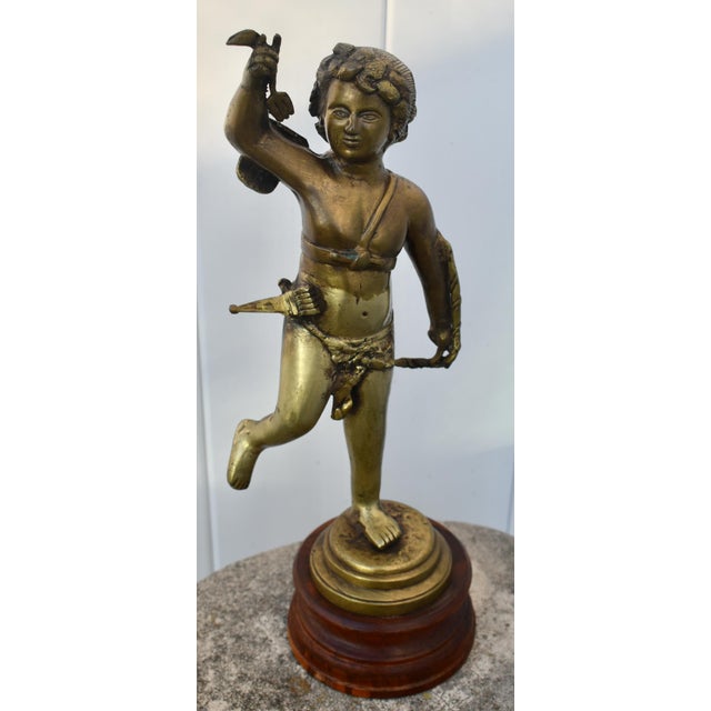 Antique- 1890's Cupid Statue has a French Style. Made of Bronze on a Wood Base. The Measurements: 6"W x 5"D x 15.5"H. Flat...