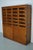 This oak haberdashery cabinet dates from the 1920/30s and was made in England. It features a wooden frame with glass...
