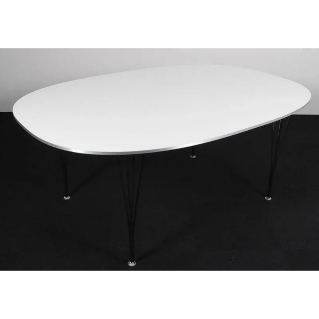 Piet Hein & Bruno Mathsson dining table original Fenix laminate. Two extension leaf of 60 cms. Legs of chromed metal....