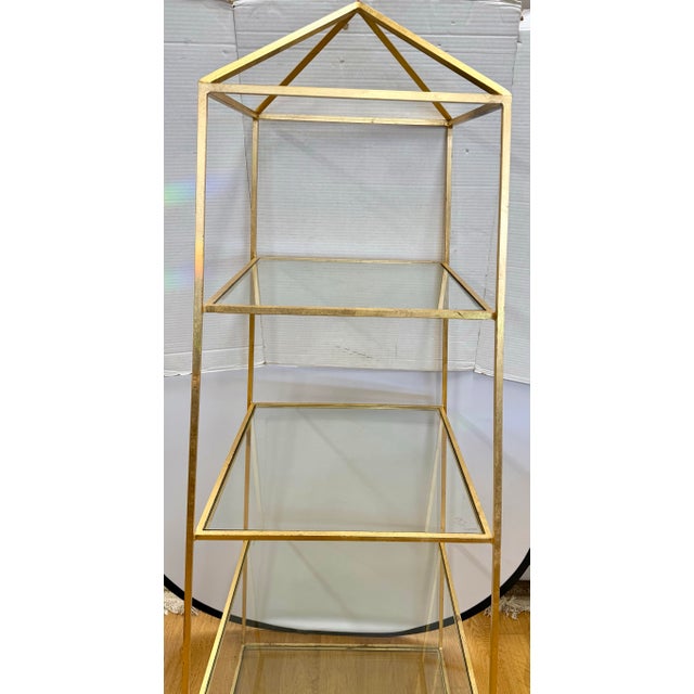 Add architectural drama and golden glamour with this striking gilt metal obelisk étagère. Designed in a sculptural obelisk...
