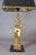 Egyptian Revival table lamp from the 1970s, with a standing gold-toned metal female figure in a stylized headdress and...