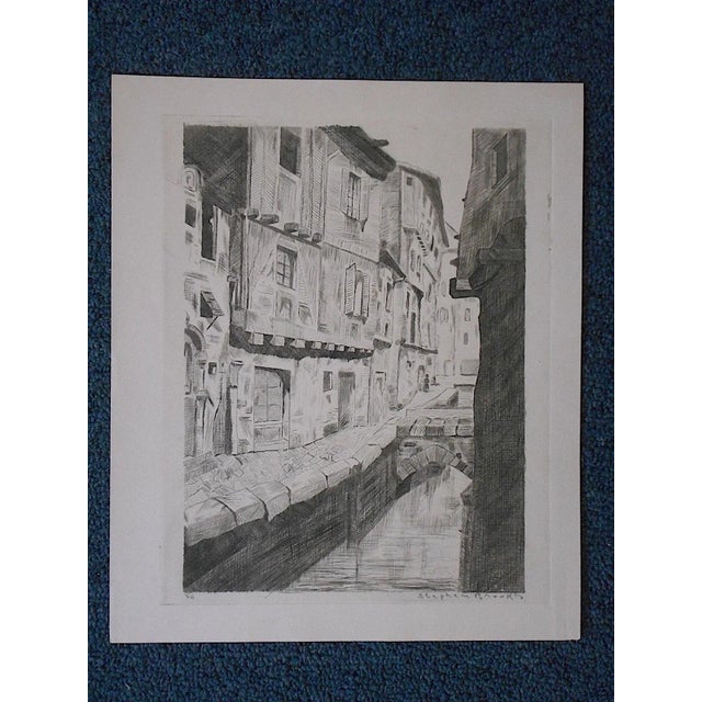 This original antique engraving appears to depict one of the scenic canals in Venice. The print is pencil signed and...