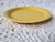 A yellow Fiestaware style small bread or dessert plate measuring 6 1/2" diameter x 1". It is unmarked and I believe to to...