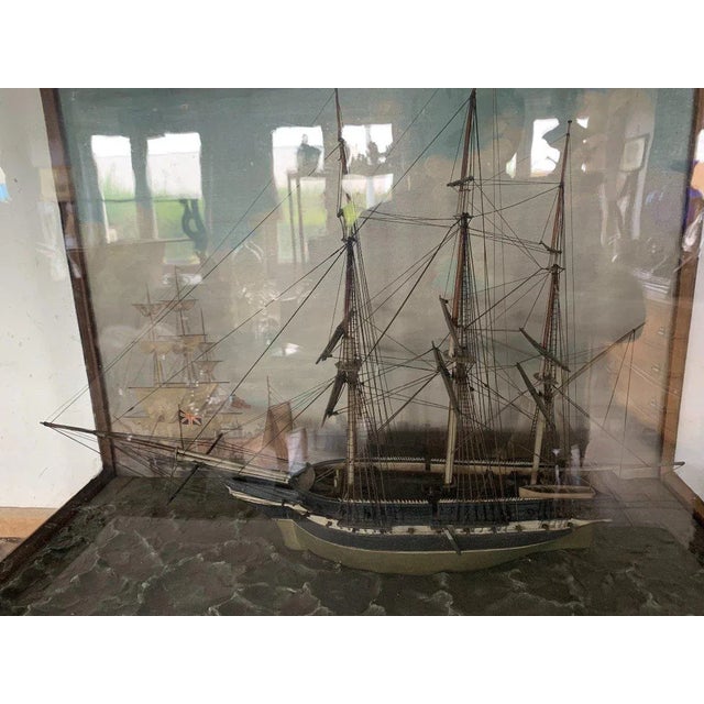Beautiful antique model of a three-masted sailing ship. Model presented in a mahogany display case. sailboat flying an...