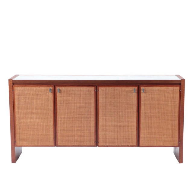 A Mid Century Modern credenza, American, circa 1960. Designed by Jack Cartwright for Founders Furniture Co ( Manufacture)....