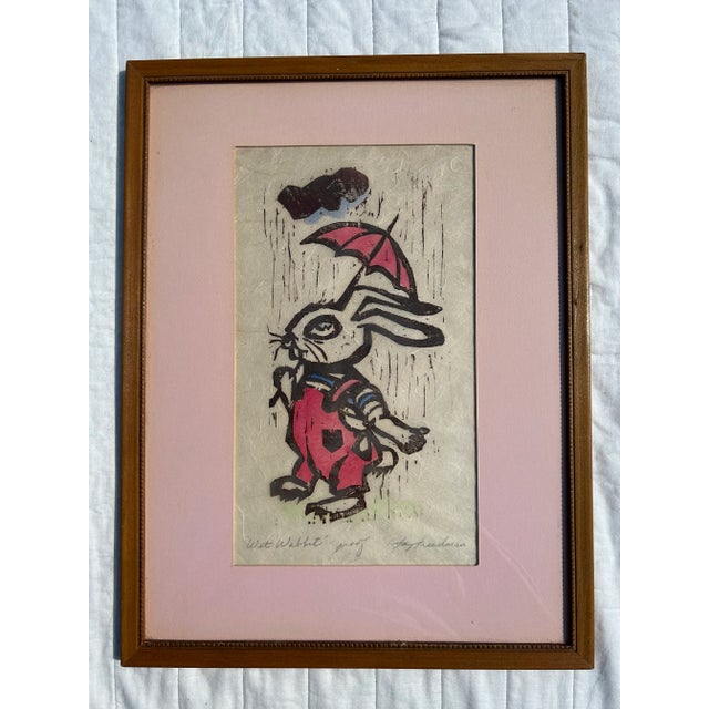 Vintage 1970’s woodcut of a rabbit holding an umbrella in the rain. Perfect for a child’s bedroom. Pencil signed and...