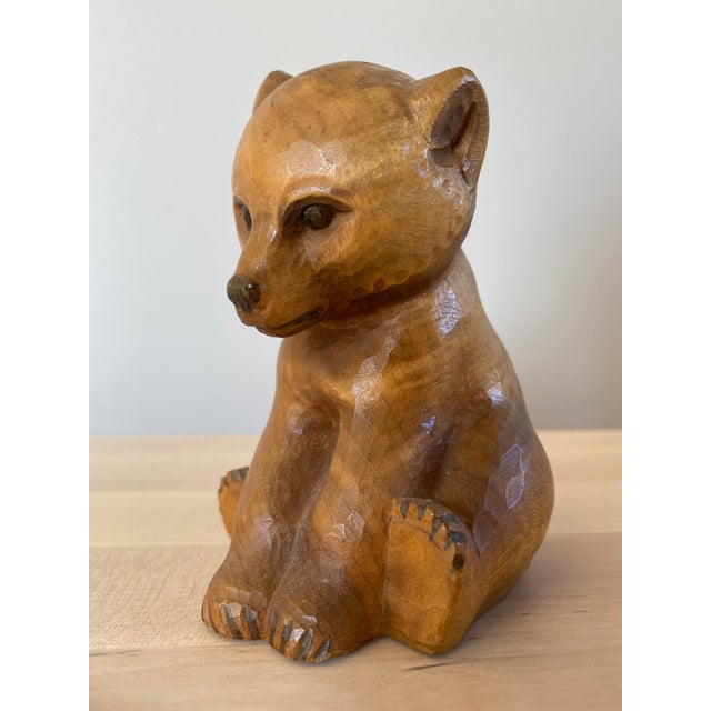 An utterly charming hand carved wood baby bear figurine by Schweizer Heimatwerk of Switzerland.