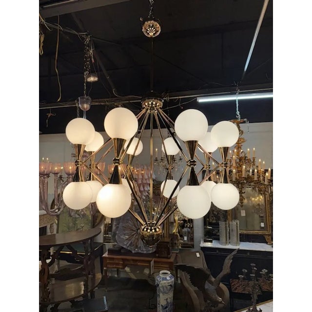 Modern large scale Italian Murano glass and polished brass atom chandelier. Sure to make a statement! 54H x 36W