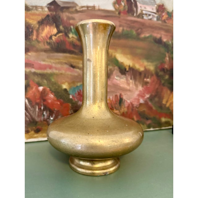 Vintage brass vase stands 7" tall and is 5" at widest point. This piece is very heavy for its size, with wonderful patina....