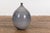 A contemporary Prem Collection artisan hand crafted ceramic vase with narrow mouth, blue grey glaze and striated effects....
