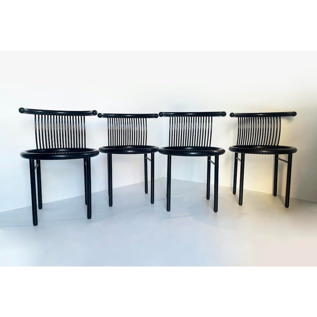 An elegant set of four Jutta & Herbert Ohl "Cirque" chairs, from the 1980s. Made entirely of black lacquered wood, they...