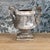 A handsome pair of iron urns with a beautiful, aged patina. Circa 1820. There is a hole in the bottom of each urn.