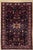 Antique hand-knotted rug from the Nahavand region of western Iran, featuring a complex central medallion set within a dark...