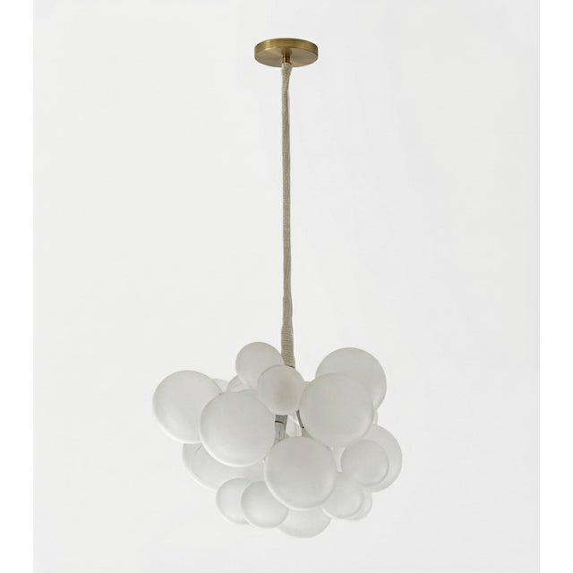 Playful yet refined, this sculptural bubble chandelier features a clustered arrangement of frosted glass globes suspended...