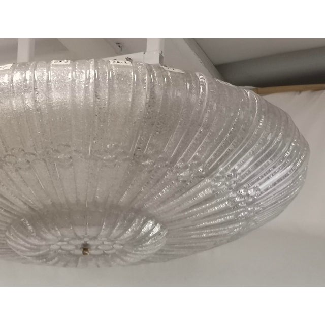 A stunning chandelier in a stunning icy white; a triumph of leaves arranged sequentially around the circular structure....