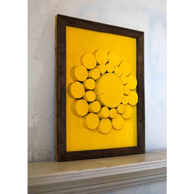 Vintage abstract geometric sculptural relief in frame. Yellow painted circular wooden elements make up this radiant piece.