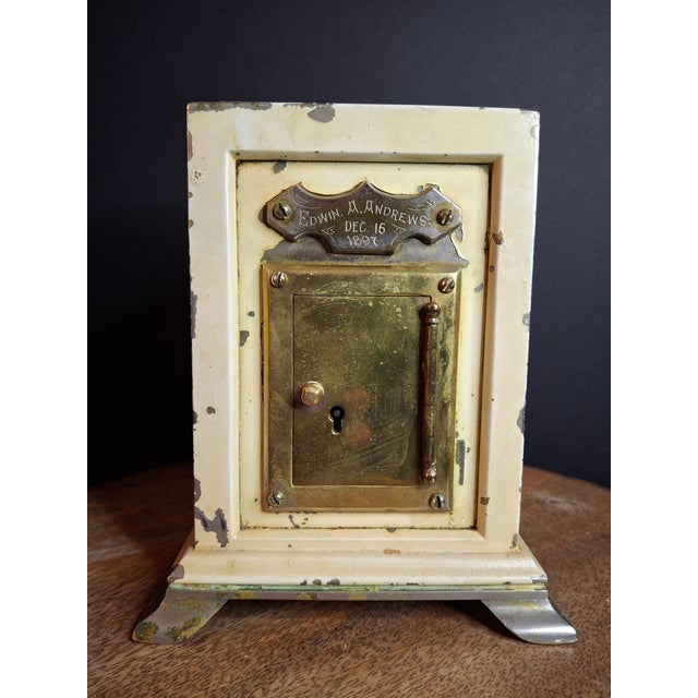 Distinguished by its extraordinary weight and custom foundry construction, this rare late 19th-century safe-form bank...