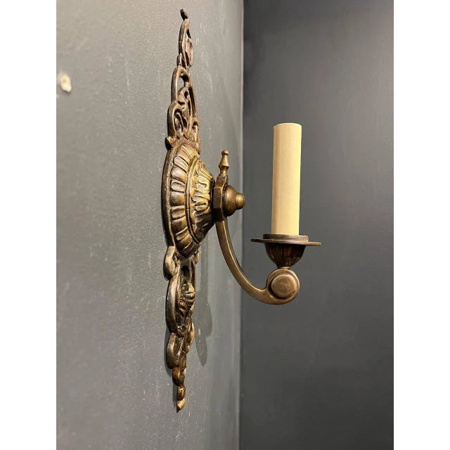 A set of 8 circa 1920’s brown paginated bronze one light sconces