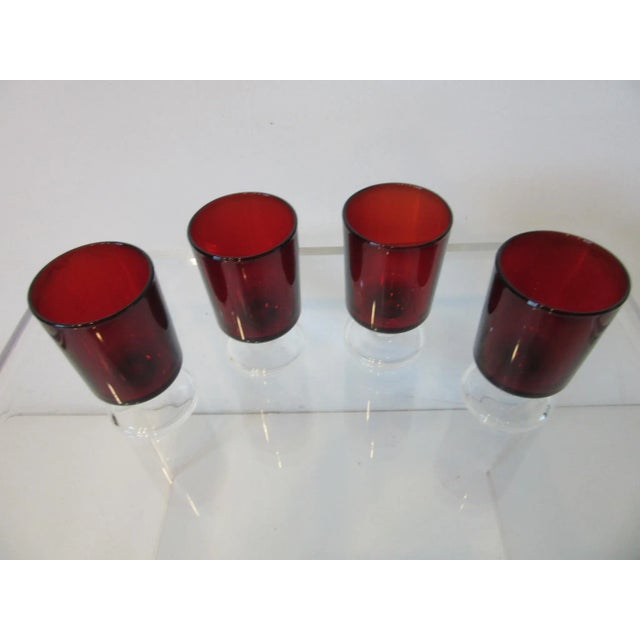 A set of four dark ruby clear stemmed cordial cocktail glasses , heavy and weighted perfectly for your hand . These...
