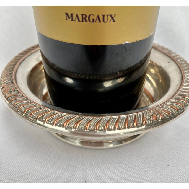 Made in England. Lovely silver wine coaster with embossed garland edge and copper accents. Perfect to serve your favorite...