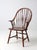 This antique American Windsor armchair features a classic brace-back design with a graceful bow crest, slender spindles,...