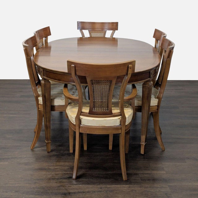 Classic Thomasville dining set featuring an oval extension table with three removable leaves and six coordinating cane-...