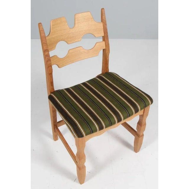 Set of striking dining chairs by Henning Kjærnulf, made of oak and original Dragør fabric as they were made originally...
