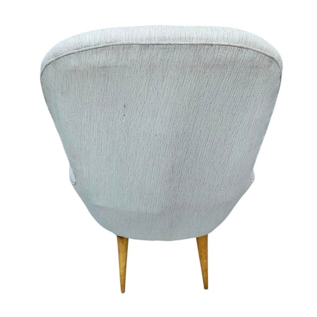 A Pair of Danish Mid-Century Armchairs. Chairs feature gently curved, button tufted backrests with generously padded seats...