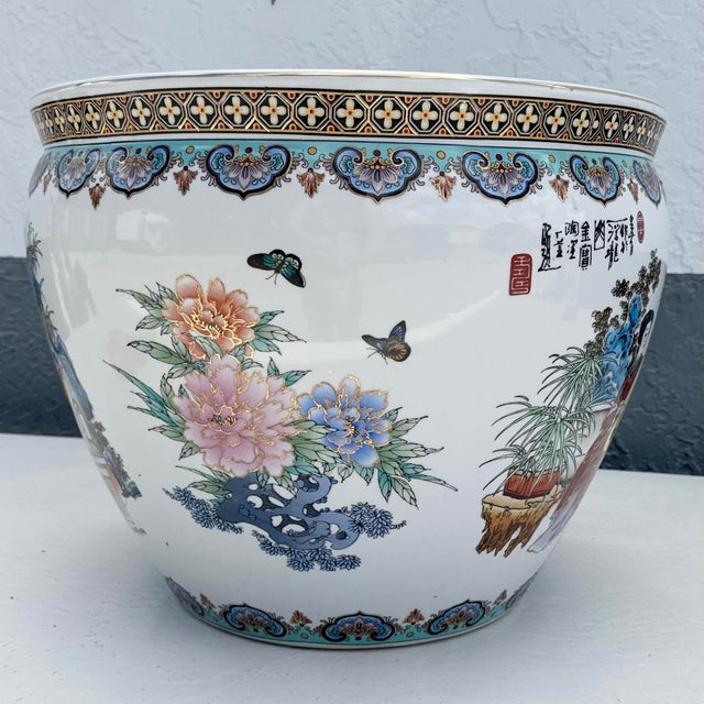 An elegant decorative statement inspired by traditional Chinese artistry, this vintage hand-painted porcelain fish bowl...