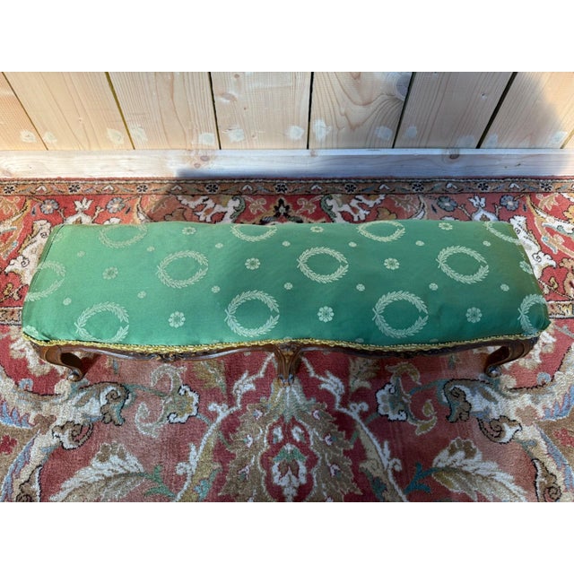 A louis xv style footstool with six cabriole legs, sculpted and ending in the characteristic volutes of this style. the...