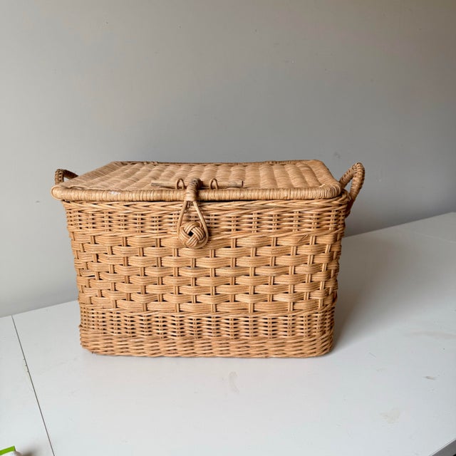 Vintage 1970s era two handle wicker basket with a hinged lid. A bit different than a traditional picnic basket.