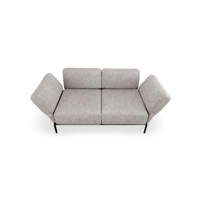 Peter maly designed this sofa for ligne roset with a single idea in mind: seat cushions that open and close like wings....