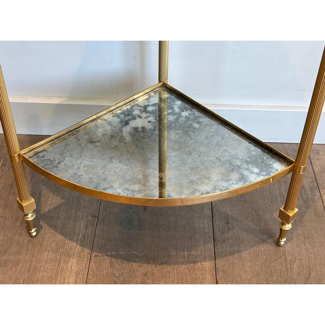 This pair of corner side tables are in gilt metal with églomisé mirror shelves. This is a French work in the style of...
