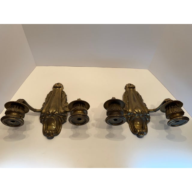 Gorgeous heavy-cast pair of French Napoleone III style two-arm wall sconces executed in highly detailed gilt bronze...