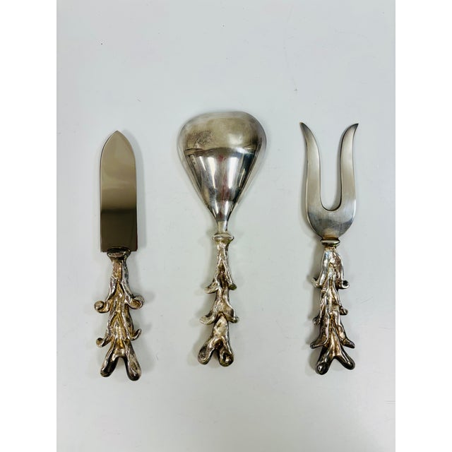 A rare and striking 3-piece silver-plated serving cutlery set designed in 1996 by Michael Aram in collaboration with...