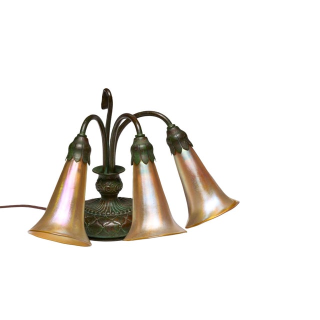 This exceptional Tiffany Studios three-light Lily piano lamp was created by Tiffany Studios of New York during the early...