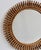 Mid-Century Italian rattan wall mirror (circa 1960s). This mirror has a complex weave of rattan in a series of horseshoe-...