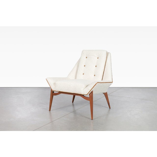 Stunning vintage sculptural walnut lounge chair, designed in the United States, circa 1950’s. This chair is the epitome of...