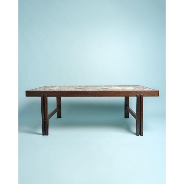 Coffee table with a ceramic top. Solid wood legs and frame. Made in Denmark. 1970s. Very nice condition, with minor signs...