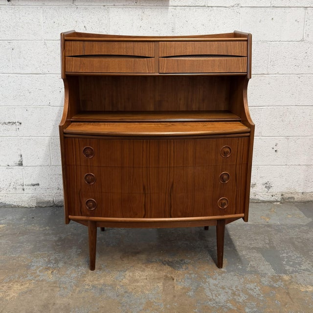 A Danish teak secretary desk from the 1960s, designed by Gunnar Falsig, with a compact upright form and an unusually...