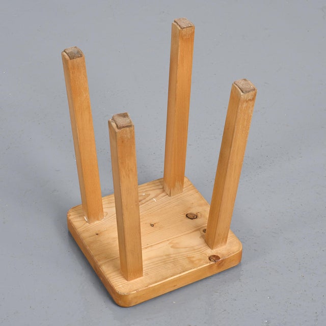 Solid pine stool with a square seat and four-legged base. It was designed for the Les Arcs ski resort, to which Charlotte...