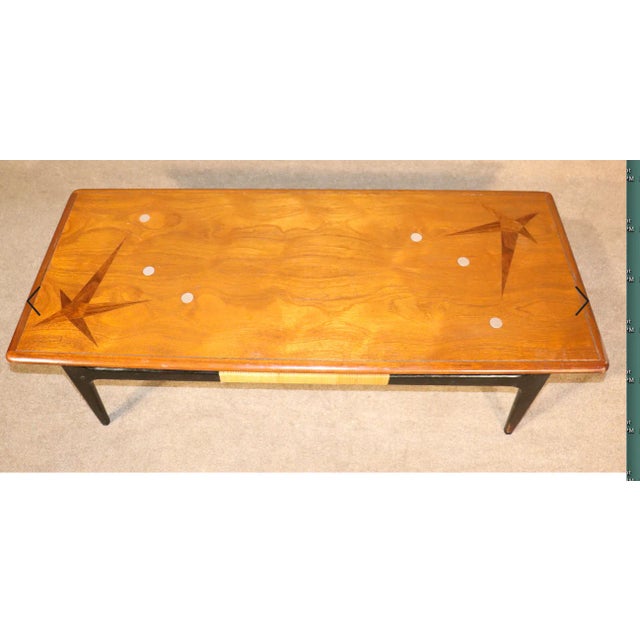 Mid-Century Modern coffee table by Lane Furniture with beautiful wood and aluminum inlay design. Ebonized base and cane...