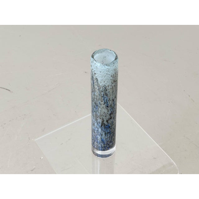 A slender, elegant studio glass vase from the swiss manufacturer sarner glas, crafted using the characteristic efeso...