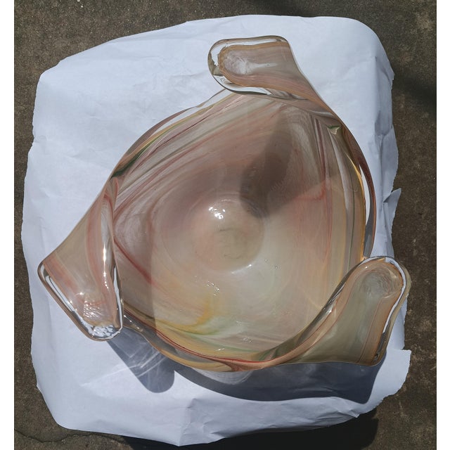 This large, hand-blown Italian art glass centerpiece bowl features an organic, freeform shape with pulled rim tips and...