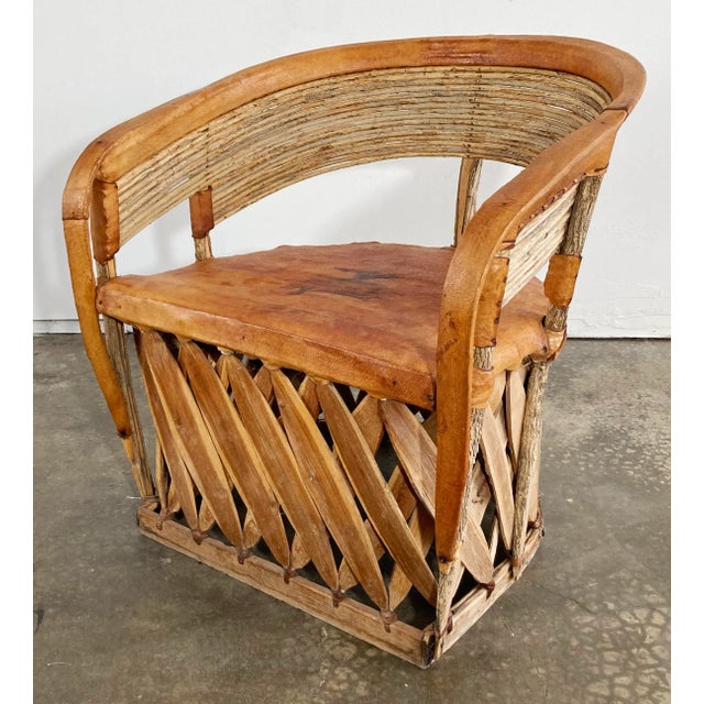 Vintage Mexican Equipale seasoned leather chair crafted from branches bent to form a barrel back frame and reinforced with...