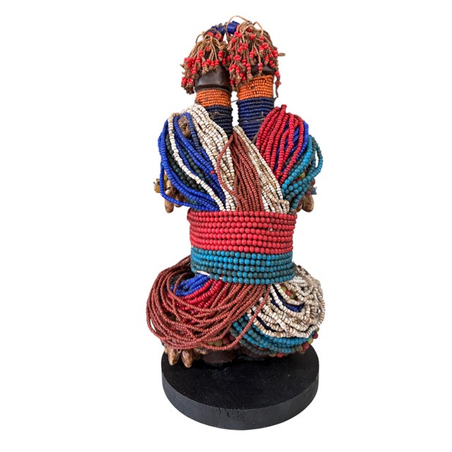 Superb vintage African Namji twin fertility dolls adorned with multiple layers of trade glass beads leather strips ;and...