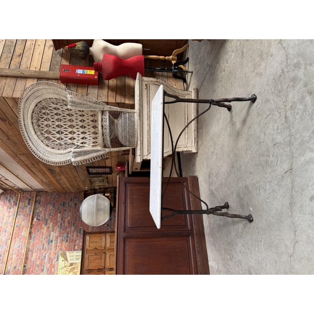 This antique bistro table has been fully restored. It features a magnificent marble tabletop and a cast-iron base engraved...