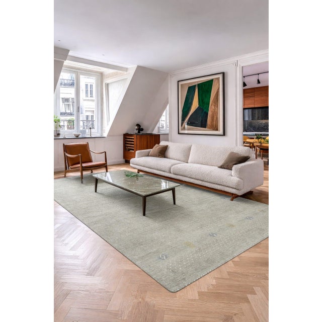 Freya Gabbeh Gray Handmade Wool Rug, Country of Origin: India. This exceptional piece reflects the modern evolution of...