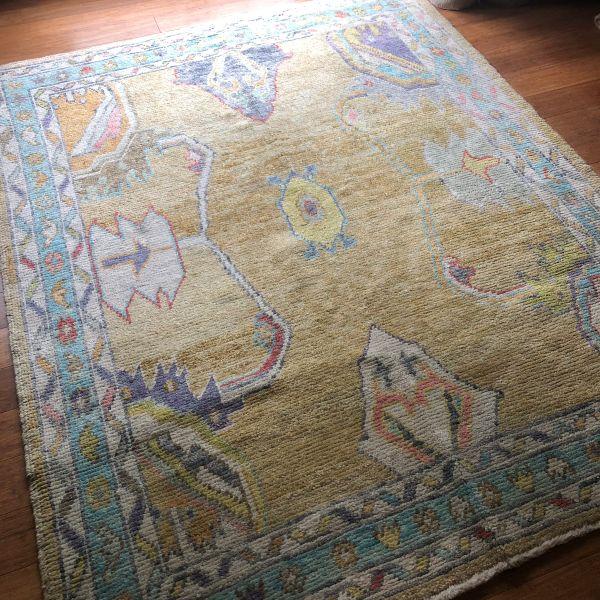A contemporary interpretation of the traditional Oushak, this hand-knotted Turkish rug is defined by its large-scale...